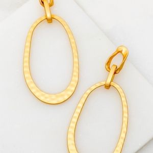 Gold hammered oval hoop earrings.